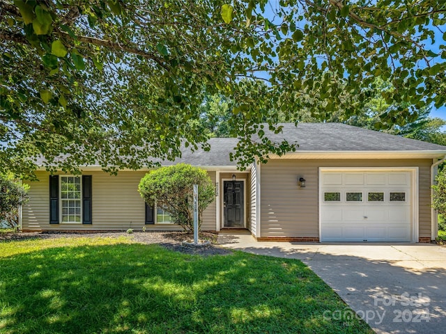 ranch-style house with a garage and a front lawn