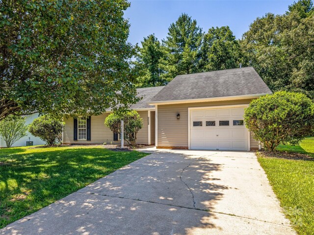 view of front of house featuring a garage and a front lawn