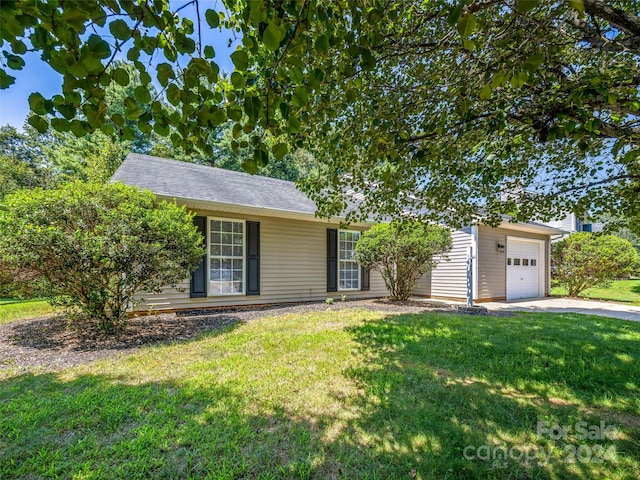 ranch-style home with a garage and a front lawn