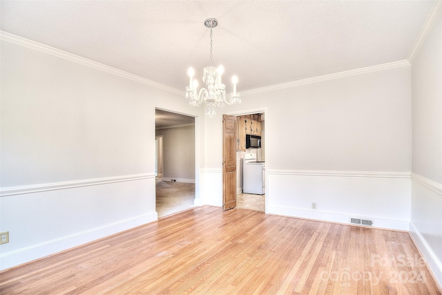 empty room with hardwood / wood-style floors, a notable chandelier, crown molding, and a textured ceiling