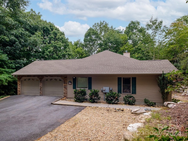2921 Connestee Trl, Brevard, NC 28712 - ranch-style house featuring driveway, an attached garage, a chimney, and roof with shingles