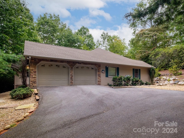 2921 Connestee Trl, Brevard, NC 28712 - ranch-style house with a garage, asphalt driveway, roof with shingles, and stone siding