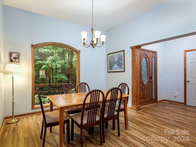 2921 Connestee Trl, Brevard, NC 28712 - dining area with light wood-type flooring, a chandelier, and baseboards