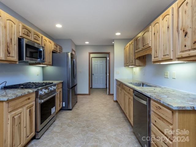 2921 Connestee Trl, Brevard, NC 28712 - kitchen featuring appliances with stainless steel finishes, light brown cabinetry, light stone finish floors, and recessed lighting