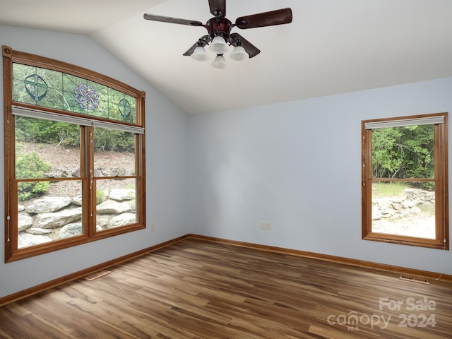 empty room featuring lofted ceiling, hardwood / wood-style floors, and ceiling fan