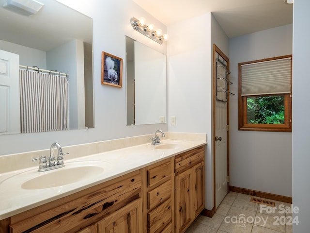 bathroom featuring tile patterned floors and vanity