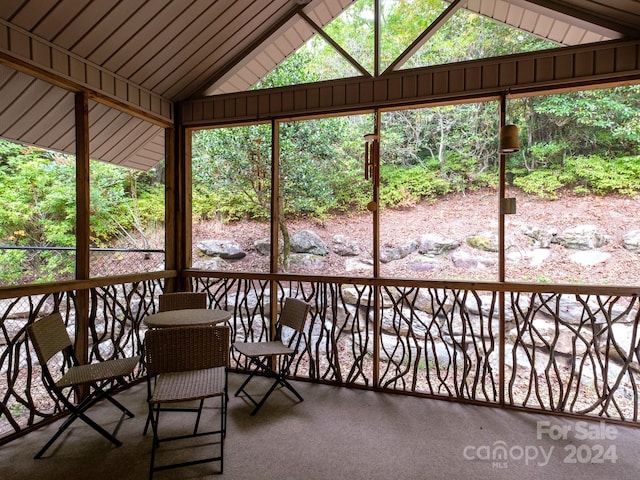 unfurnished sunroom with vaulted ceiling