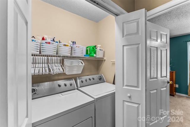 washroom with laundry area, baseboards, light colored carpet, a textured ceiling, and separate washer and dryer