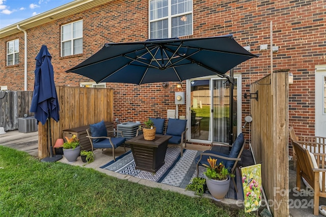 view of patio with central AC unit, fence, and an outdoor hangout area