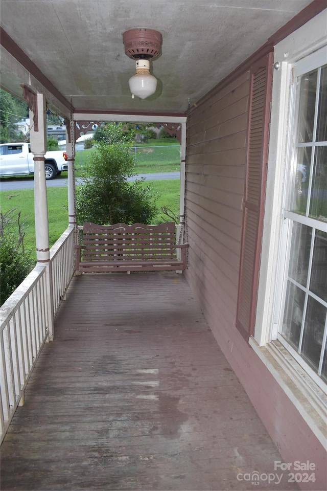 wooden deck featuring a lawn