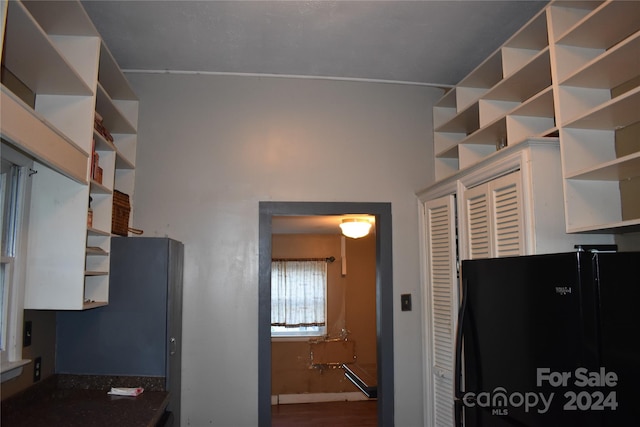 interior space featuring black refrigerator and hardwood / wood-style floors