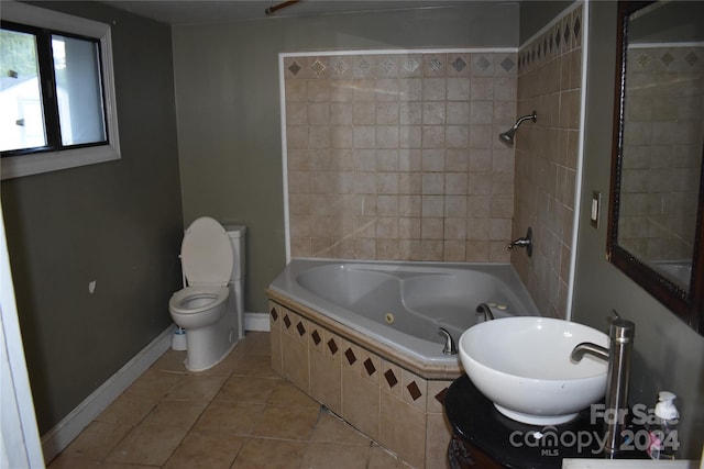 full bathroom featuring toilet, vanity, tiled shower / bath, and tile patterned floors