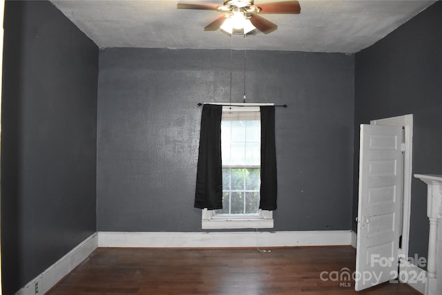 empty room with ceiling fan and hardwood / wood-style floors