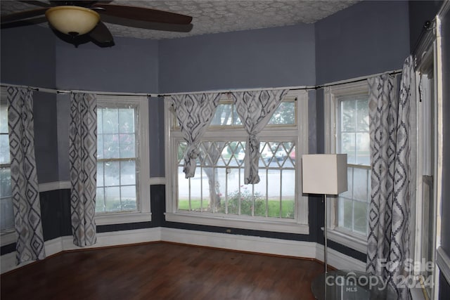 spare room with ceiling fan, plenty of natural light, and hardwood / wood-style flooring