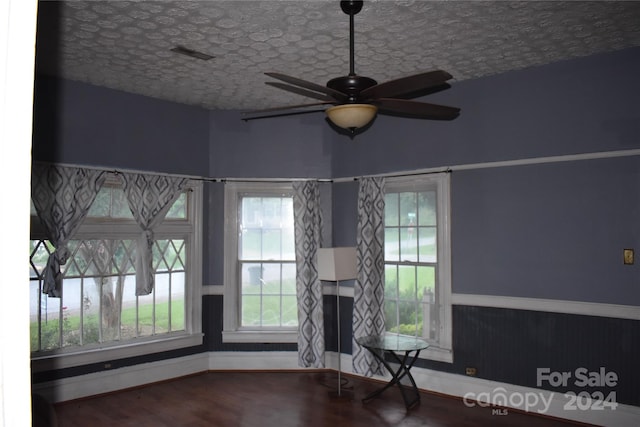 unfurnished living room with ceiling fan and hardwood / wood-style flooring