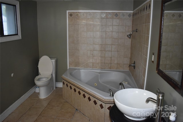 full bathroom featuring sink, tiled shower / bath, toilet, and tile patterned flooring