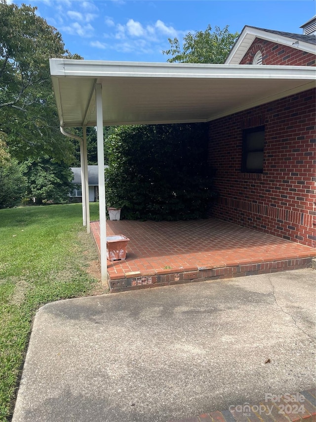 view of car parking featuring a yard and a carport