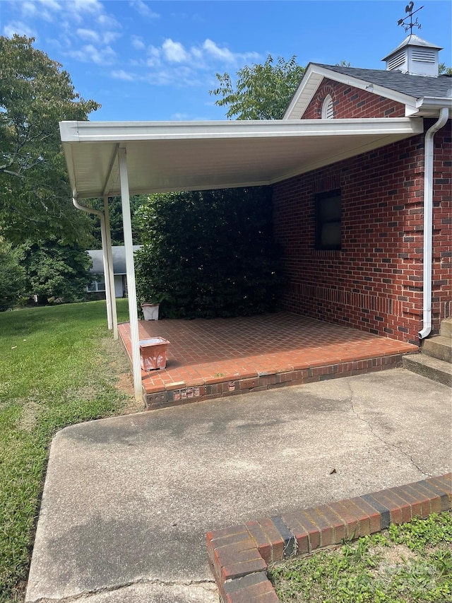 view of parking with a yard and a carport