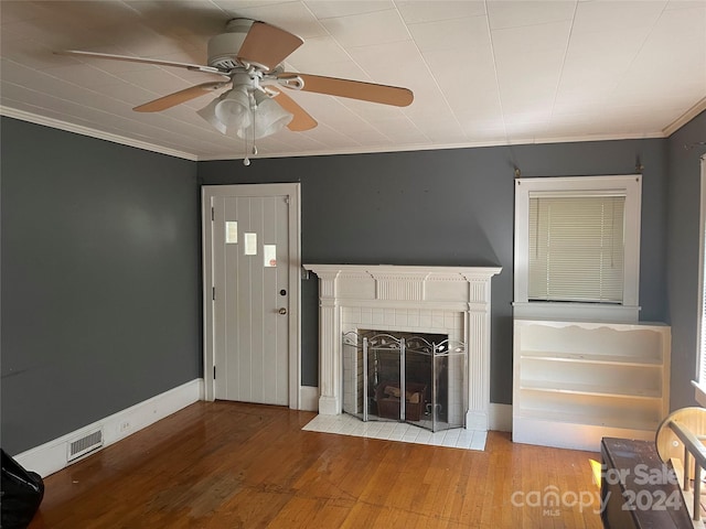 unfurnished living room featuring crown molding, light hardwood / wood-style flooring, and a fireplace