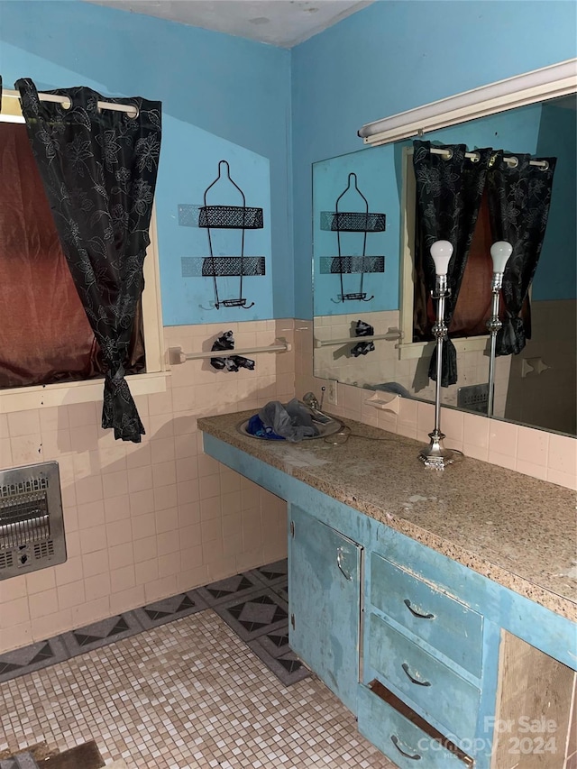 bathroom with vanity, tile patterned floors, and tile walls