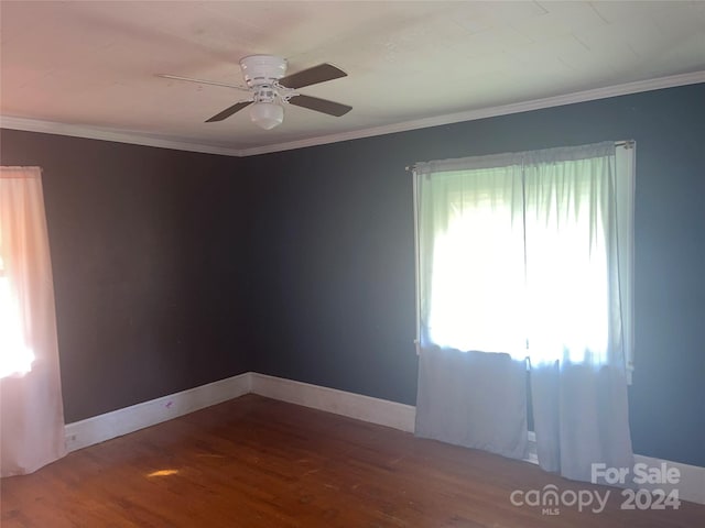 spare room with crown molding, hardwood / wood-style flooring, and ceiling fan