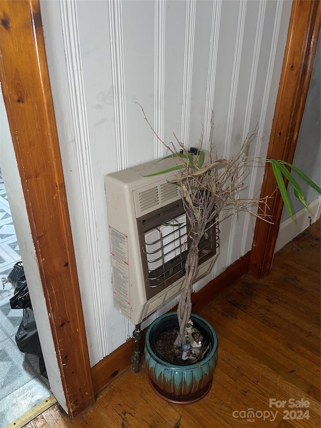 room details with wood-type flooring and heating unit