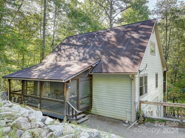 back of house with a sunroom