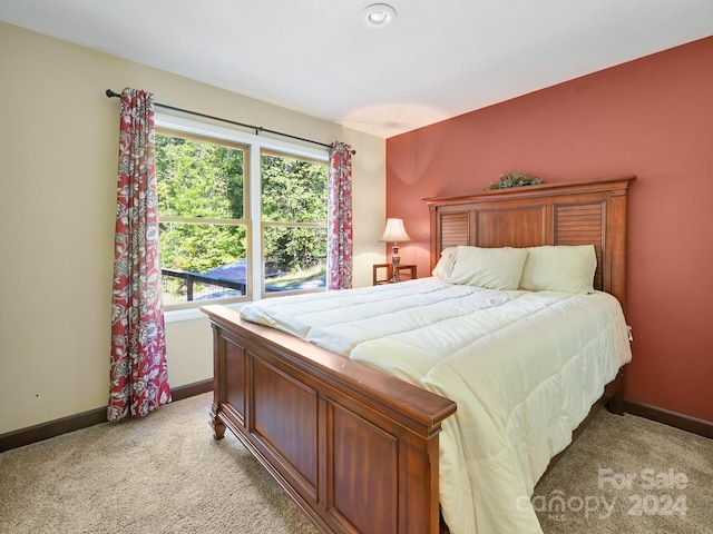 bedroom featuring light carpet