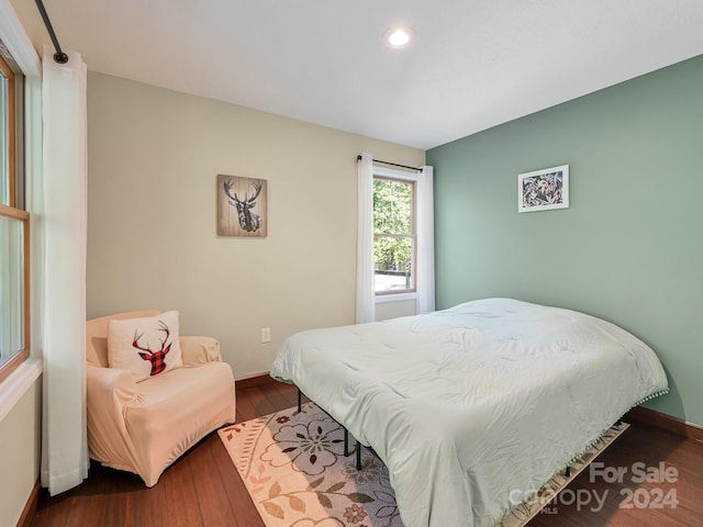 bedroom with dark wood-type flooring