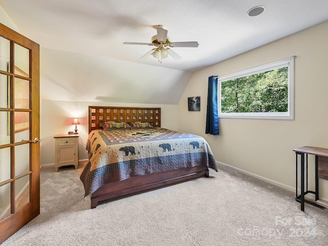 carpeted bedroom with lofted ceiling and ceiling fan