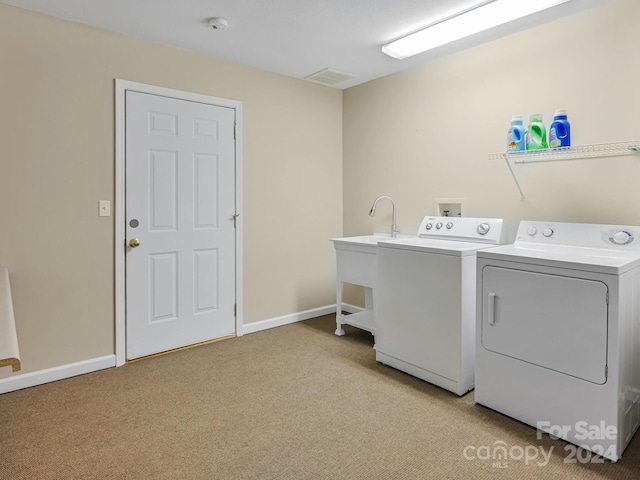 laundry room featuring light colored carpet and washing machine and clothes dryer