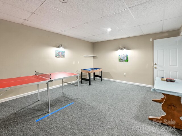 playroom with a drop ceiling and carpet floors