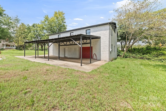 back of property with a patio area, brick siding, and a yard