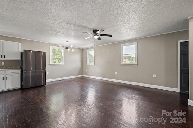 unfurnished living room featuring ceiling fan with notable chandelier, crown molding, a textured ceiling, and dark hardwood / wood-style flooring