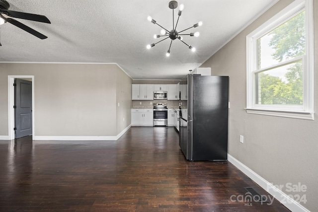 kitchen with dark wood-type flooring, white cabinetry, baseboards, light countertops, and appliances with stainless steel finishes