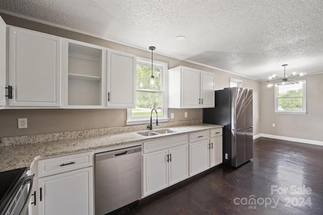 kitchen featuring dark wood-type flooring, a sink, white cabinets, appliances with stainless steel finishes, and plenty of natural light