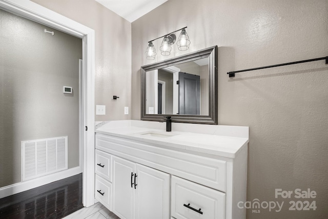 bathroom with vanity and visible vents