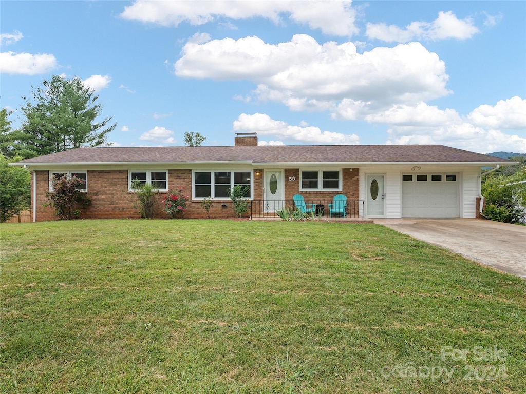 single story home featuring a garage, concrete driveway, a chimney, and a front yard