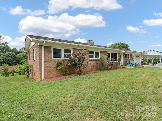 ranch-style home with a patio and a front yard