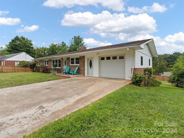 ranch-style house featuring a front yard and a garage