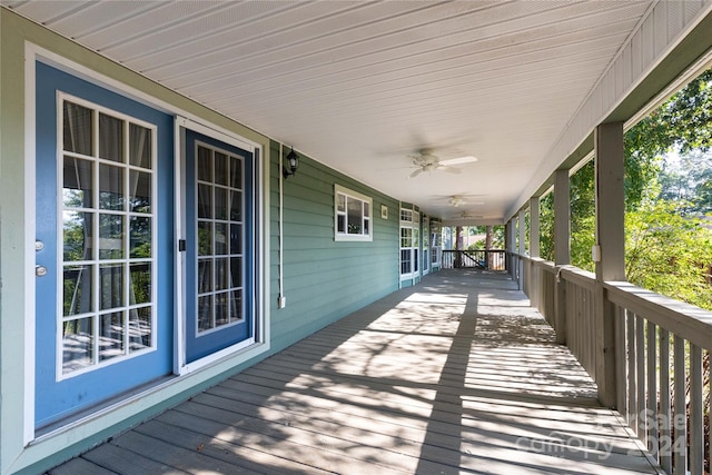 wooden terrace with a porch and ceiling fan