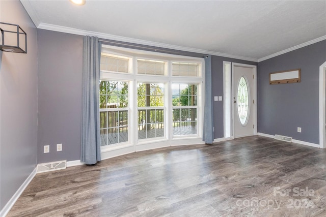 entrance foyer featuring crown molding and dark hardwood / wood-style floors