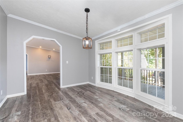 unfurnished room with wood-type flooring, a textured ceiling, and ornamental molding