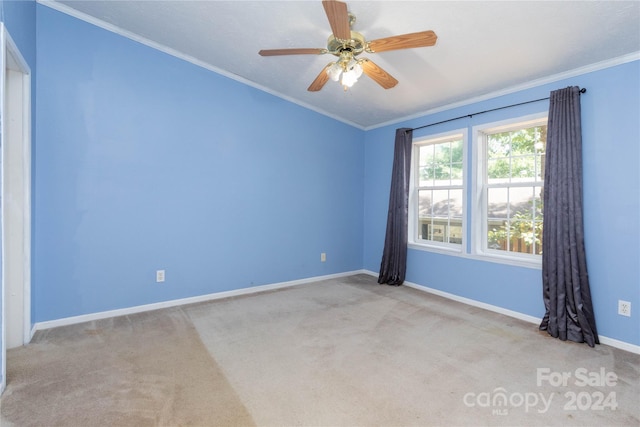 unfurnished room featuring light colored carpet, ceiling fan, and ornamental molding