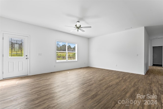 unfurnished living room featuring dark hardwood / wood-style floors and ceiling fan