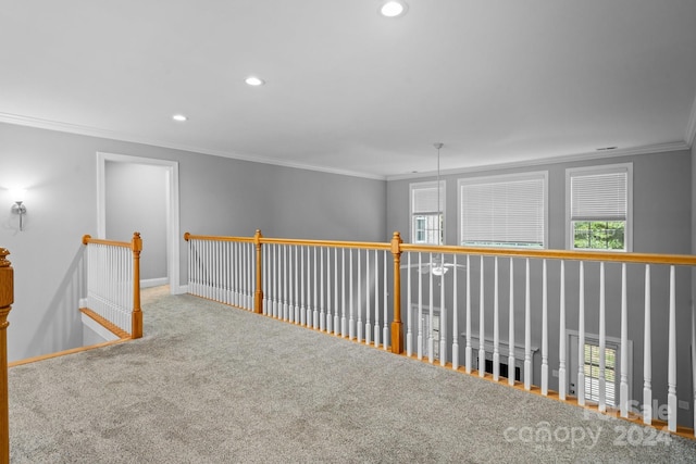 hallway with carpet floors and ornamental molding