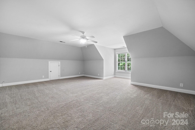 additional living space with carpet, ceiling fan, and lofted ceiling