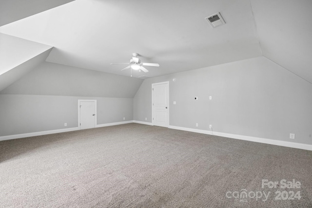 additional living space with carpet, vaulted ceiling, and ceiling fan