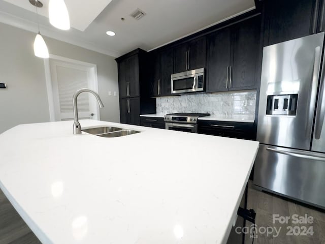 kitchen with dark wood-type flooring, sink, appliances with stainless steel finishes, and tasteful backsplash