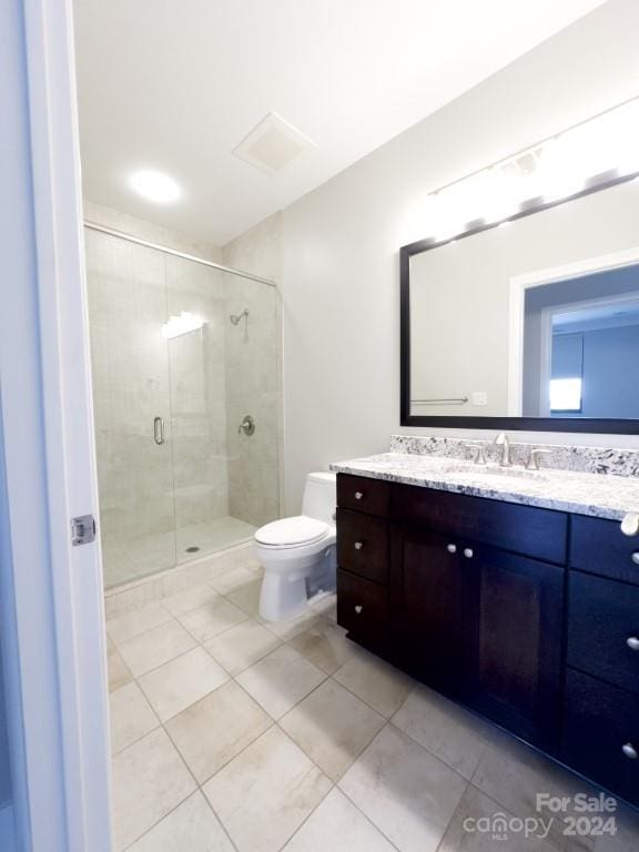 bathroom featuring an enclosed shower, tile patterned flooring, toilet, and vanity